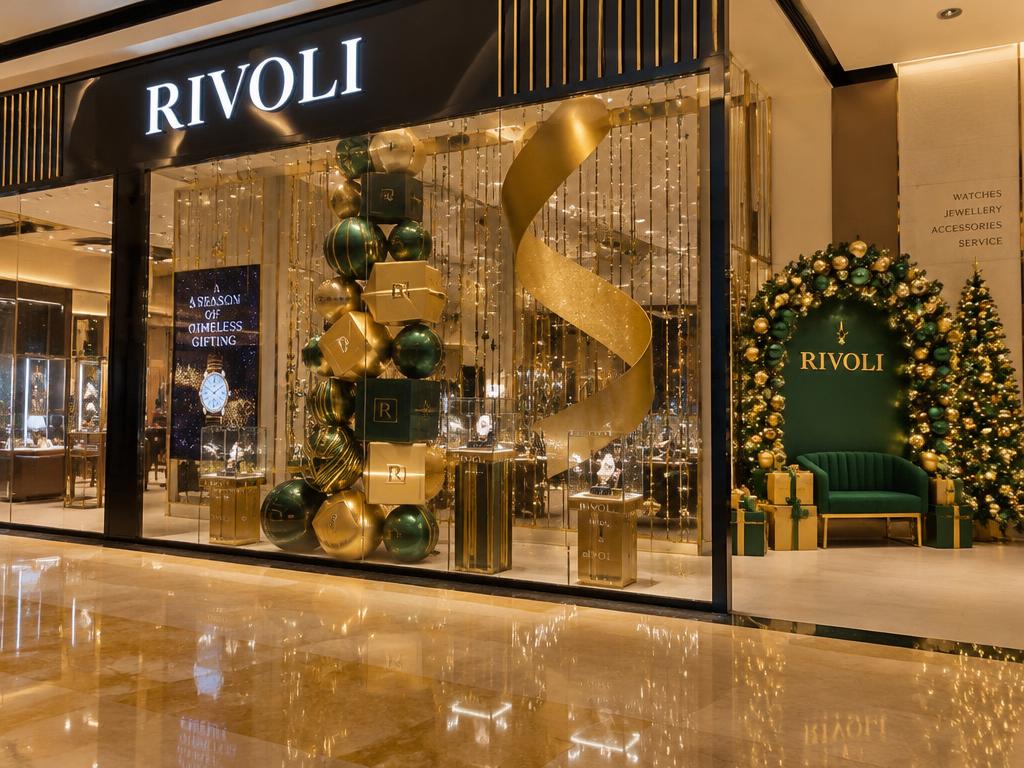 Christmas retail window display with gold and emerald styling